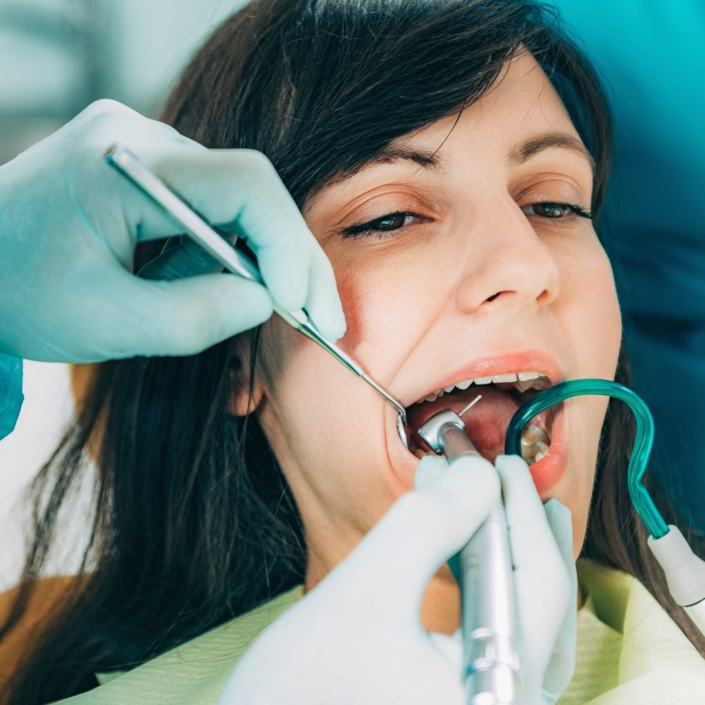 Dentist Working with Young Female Patient